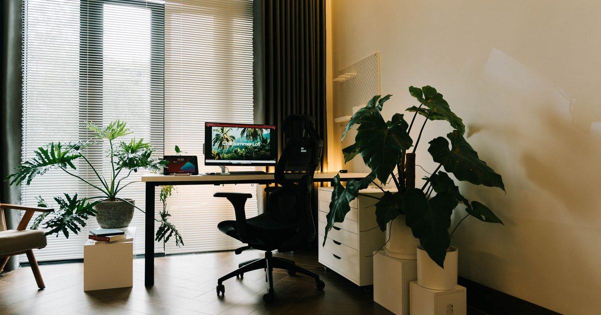 a black office chair on a dark wooden floor in a home office