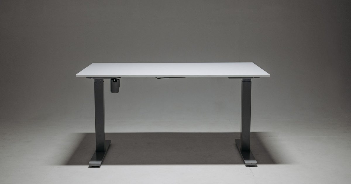 a height adjustable standing desk with electric legs and a white top